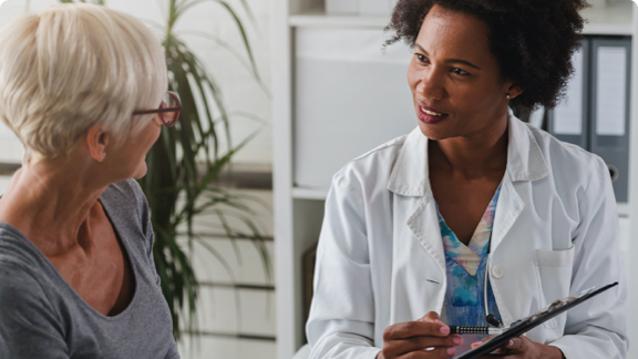 Female doctor counseling female patient.